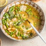 White beans in a parmesan broth with peas and asparagus