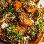 Roasted squash with lentils and yogurt on a serving plate.