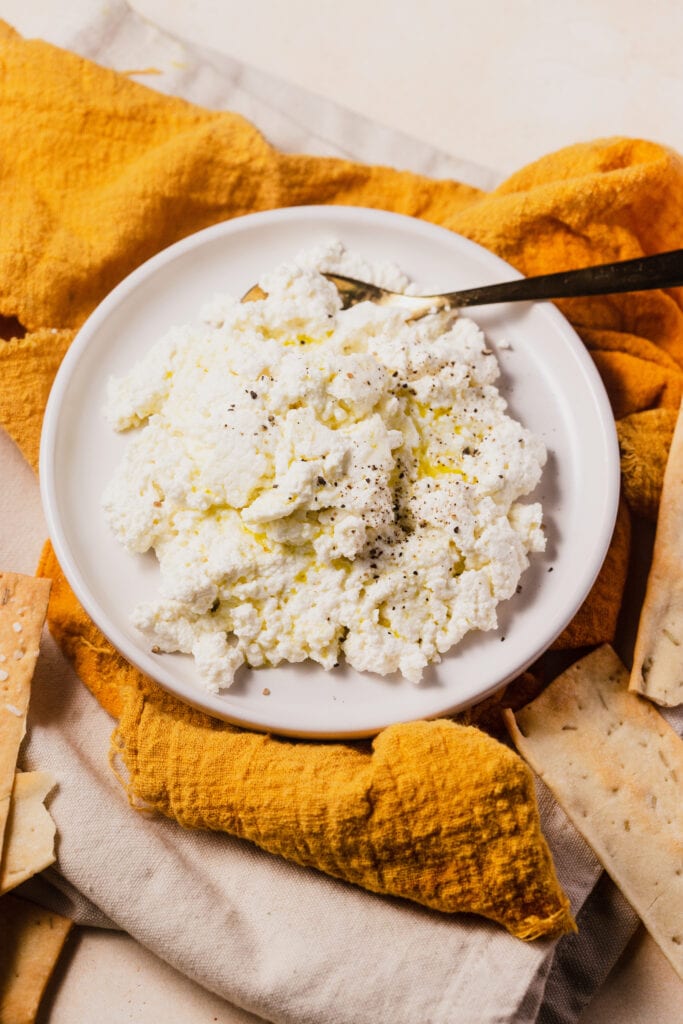 Whole milk ricotta cheese with olive oil, salt, and crackers