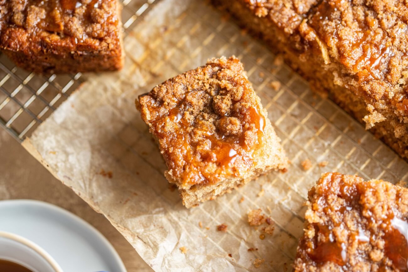 Slices of apple cider coffee cake on parchment paper.