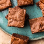Plate of fudgy greek yogurt brownies topped with flaky sea salt.