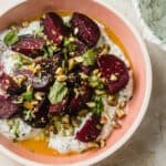 bowl of roasted beets with skyr and pistachio and herbs