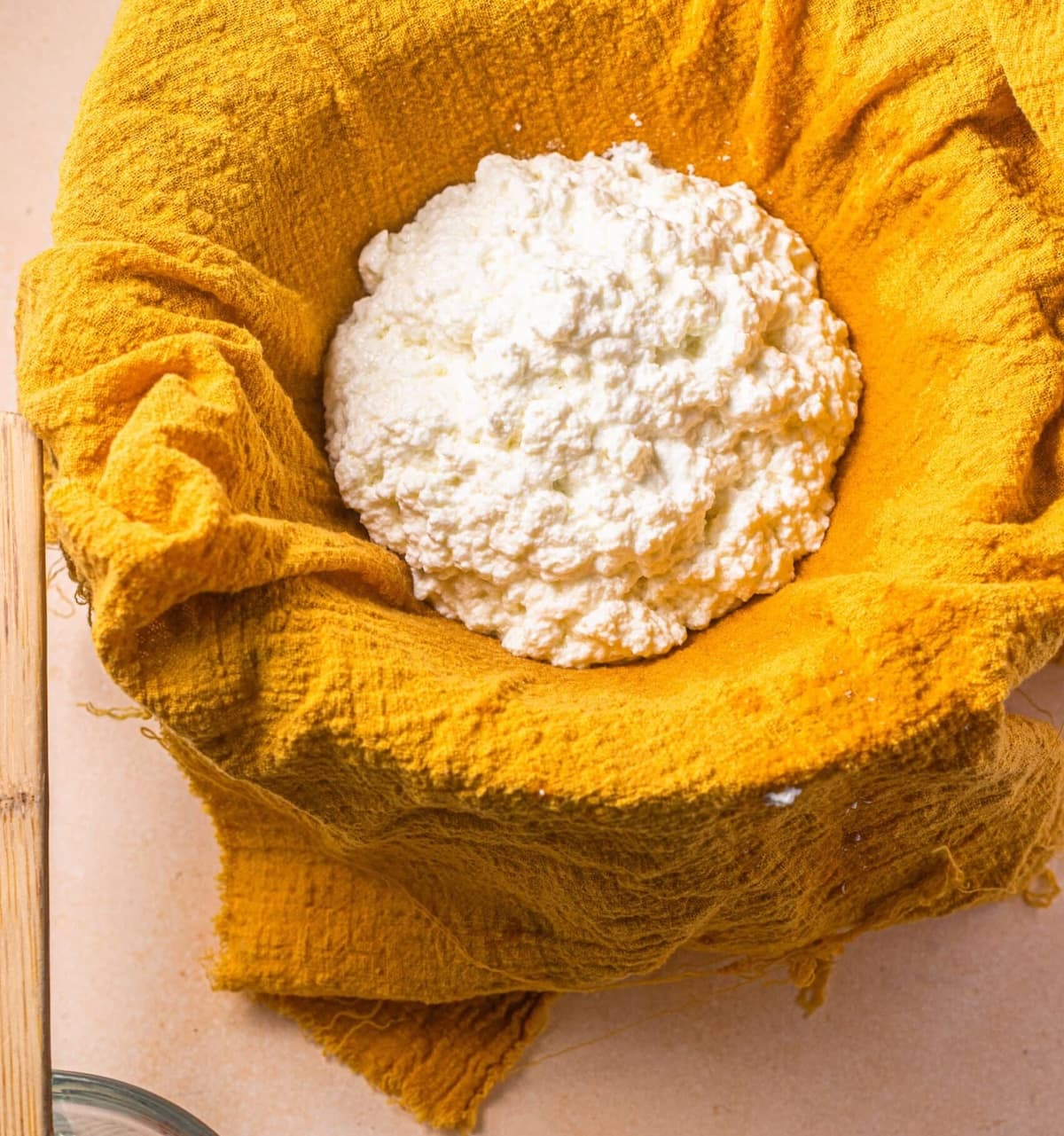 Ricotta draining in a cheesecloth.