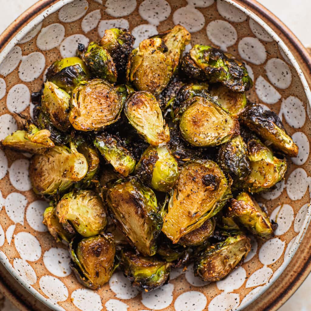 Caramelized roasted brussels sprouts with a balsamic maple glaze in a bowl.