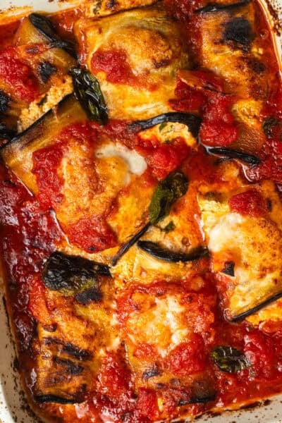 Eggplant parcels stuffed with ricotta in tomato sauce and baked.