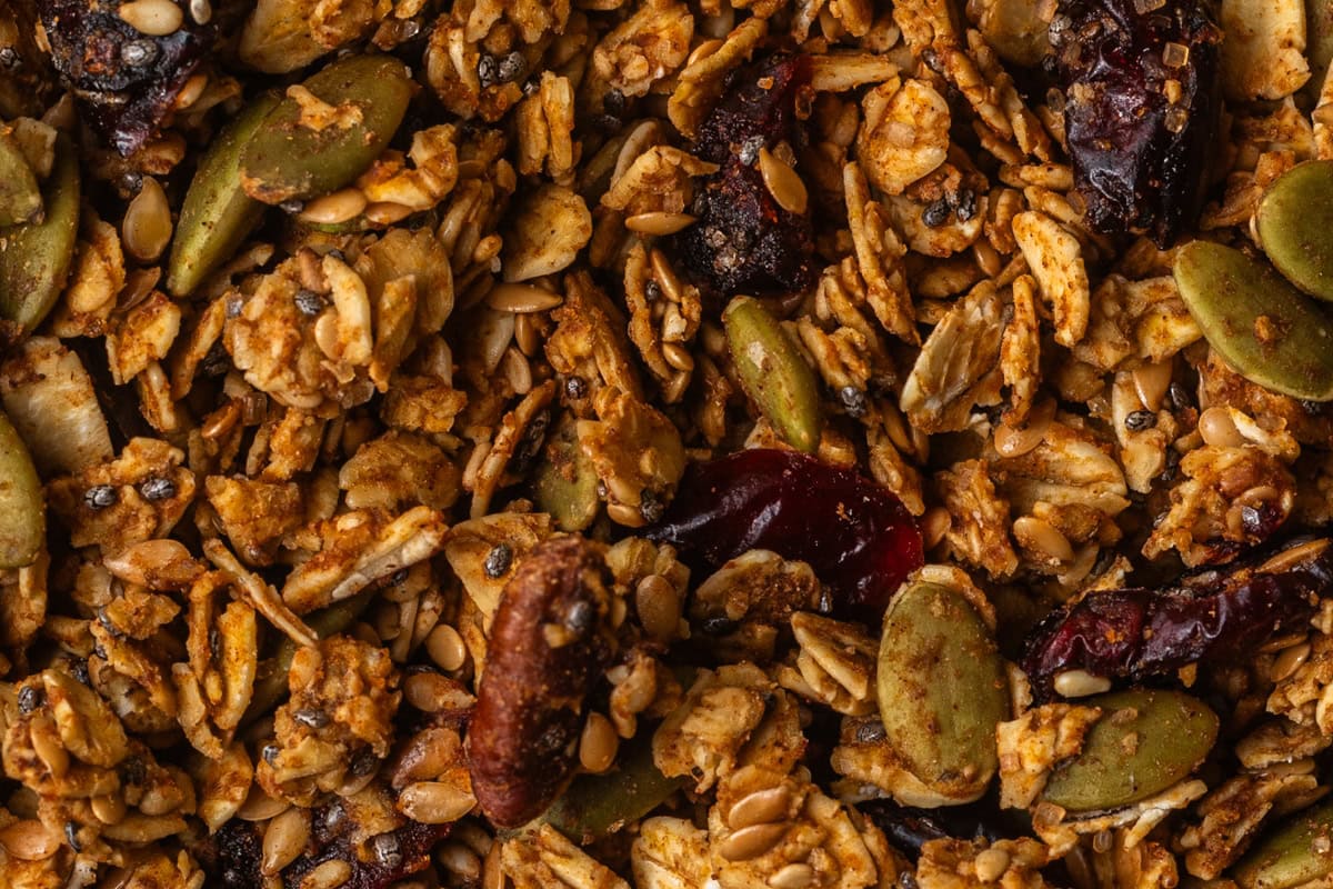 Toasted granola with pepitas, pecans, chia seeds, and oats mixed together.