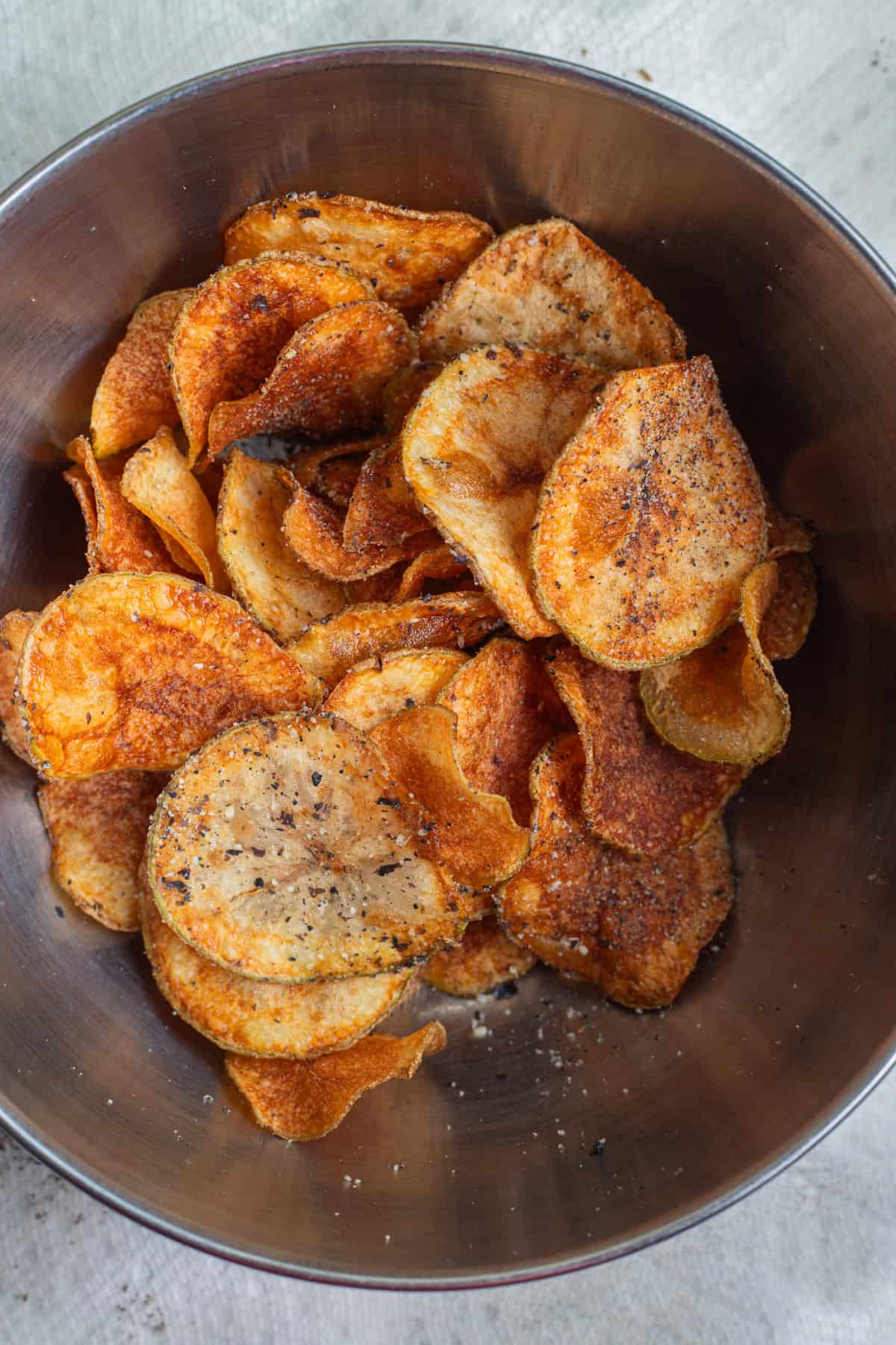 A bowl of homemade potato chips dusted with nori.